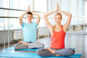 veledora-Young couple practicing yoga